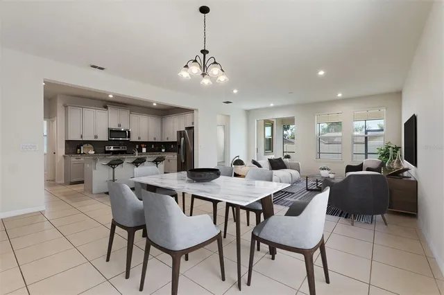 a view of kitchen with refrigerator dining table and chairs