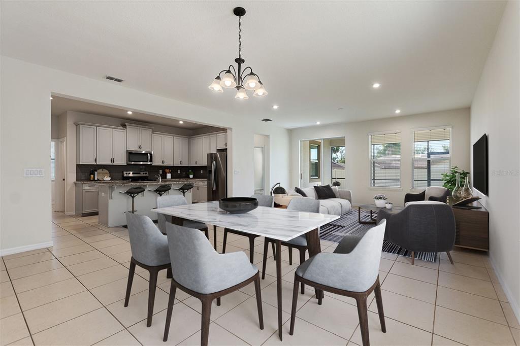2500 Avian Loop Kissimmee, FL 34741 - Photo 12 of 35 a view of kitchen with refrigerator dining table and chairs