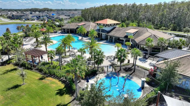 an aerial view of a house with garden space and lake view