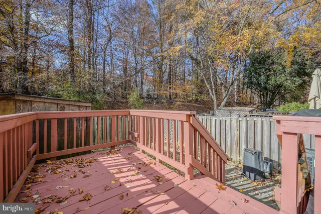 a view of balcony with wooden floor and fence