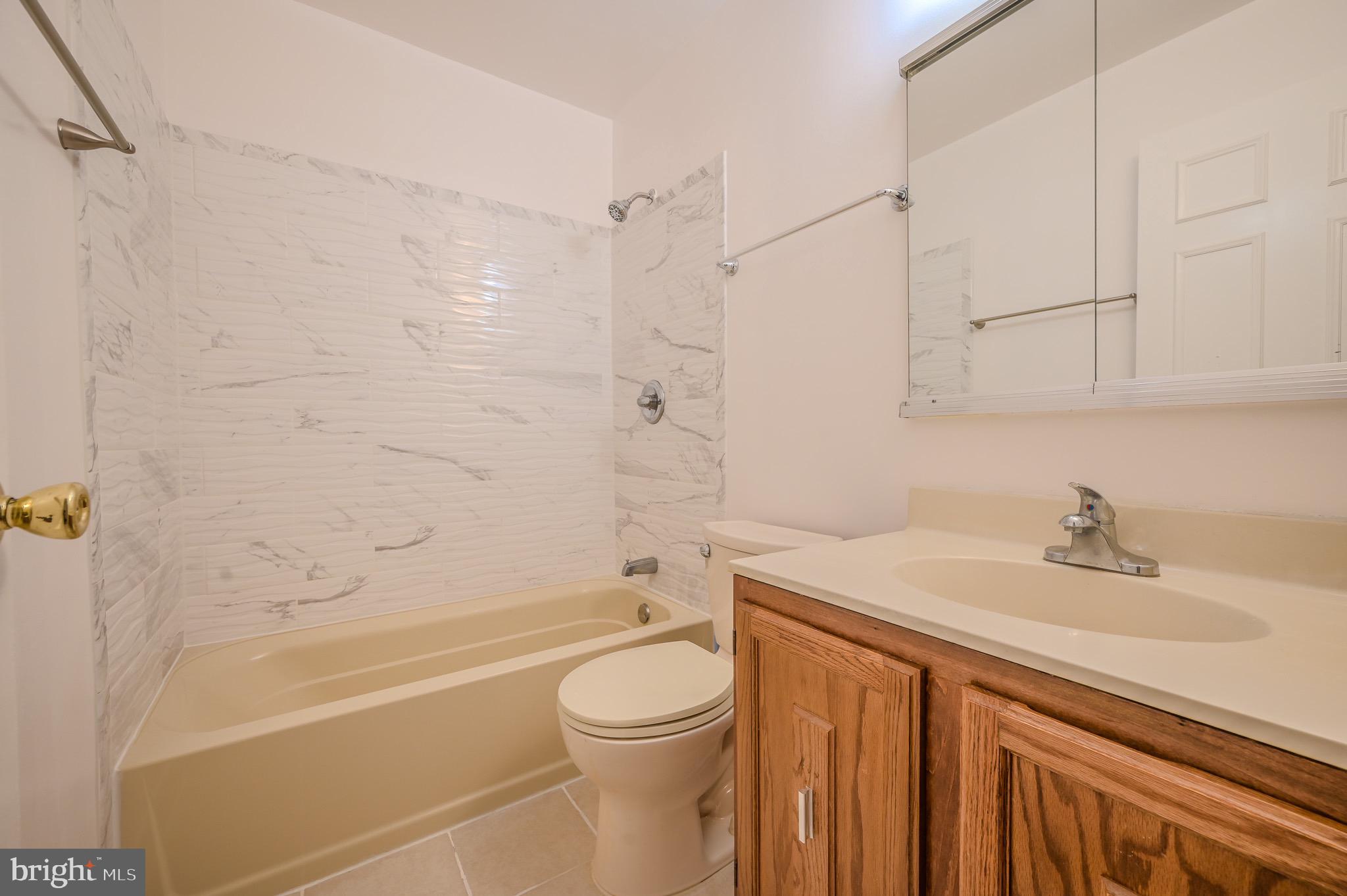 6260 Rathlin Drive Springfield, VA 22152 - Photo 10 of 11 a bathroom with a sink a toilet and a bathtub
