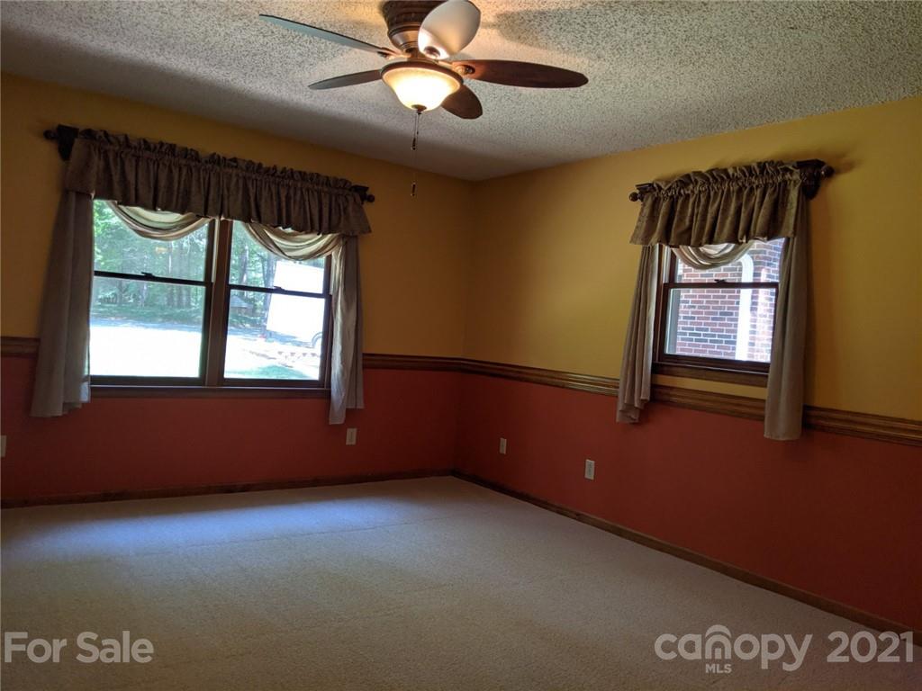 826 Potter Road Monroe, NC 28110 - Photo 11 of 20 an empty room with windows and fan