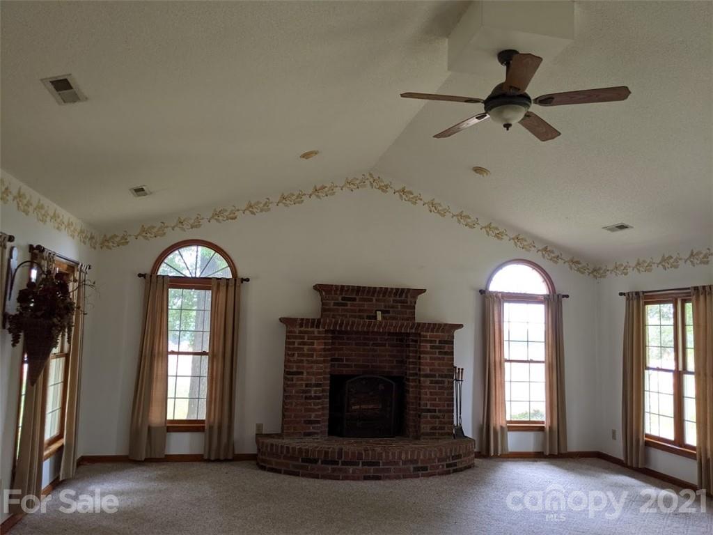 826 Potter Road Monroe, NC 28110 - Photo 5 of 20 a view of a livingroom with a fireplace and windows