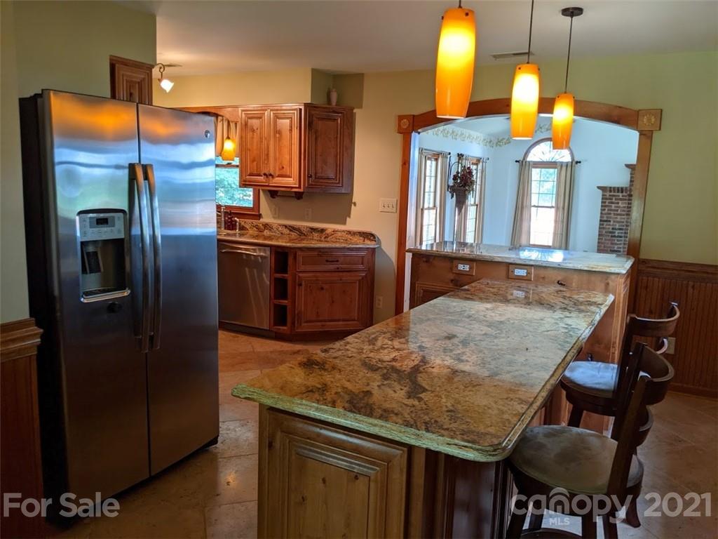 826 Potter Road Monroe, NC 28110 - Photo 9 of 20 a kitchen with stainless steel appliances granite countertop a stove refrigerator and microwave