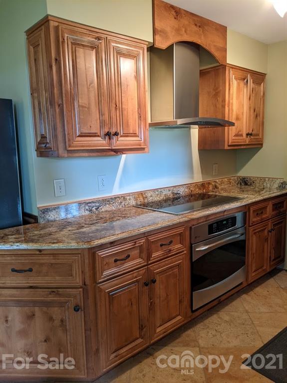 826 Potter Road Monroe, NC 28110 - Photo 10 of 20 a kitchen with granite countertop a stove and a sink