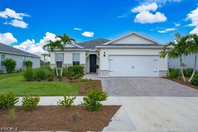 a front view of a house with a yard and a garage
