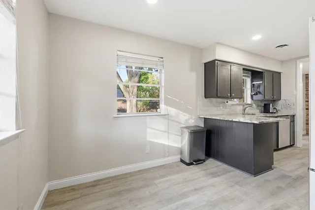 a kitchen with stainless steel appliances granite countertop a sink and a stove top oven