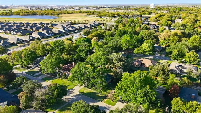 a view of a house with a large window and wooden fence