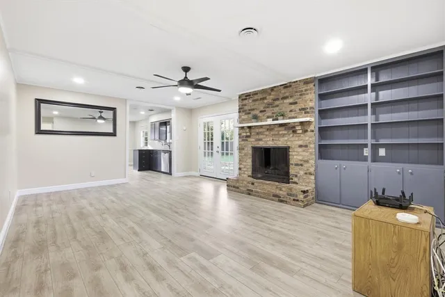 a view of a livingroom with a fireplace and cabinet