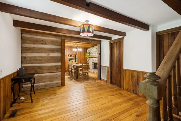 a view of a house with backyard and a tree