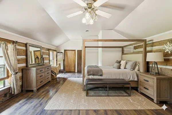 a view of a livingroom with a workspace a ceiling fan and a rug