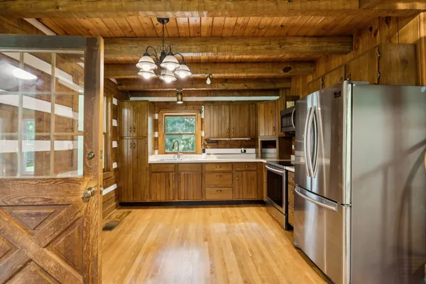 a view of a field with trees in the background