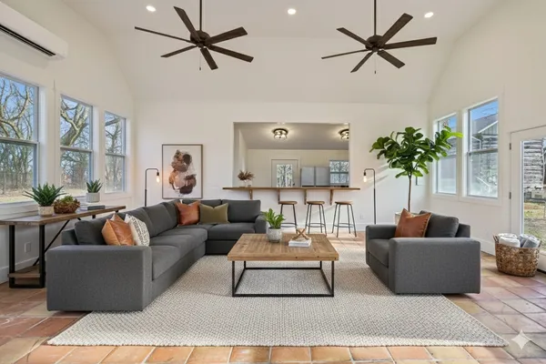 an aerial view of residential houses with outdoor space and trees