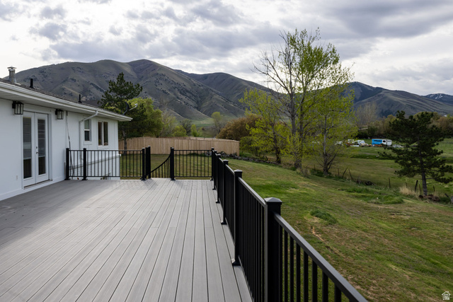 4155 Johnson Road Nibley, UT 84321 - Photo 47 of 71 Wooden terrace with french doors, a mountain view, and a view of rural / pastoral area