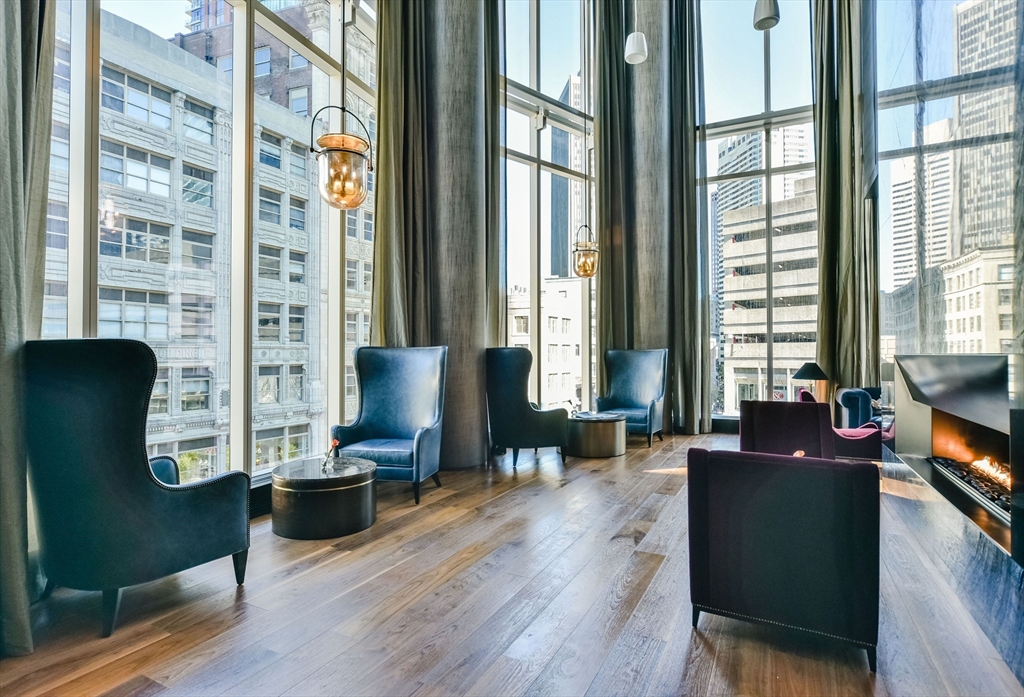 1 Franklin Street, Unit 1003 Boston, MA 02110 - Photo 11 of 12 a living room with furniture and a flat screen tv
