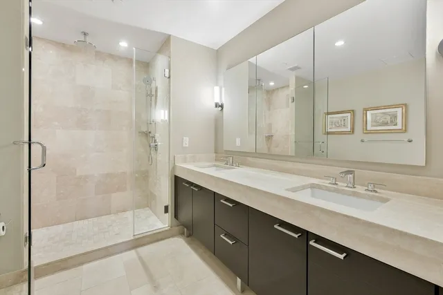 a bathroom with a shower sink double and mirror