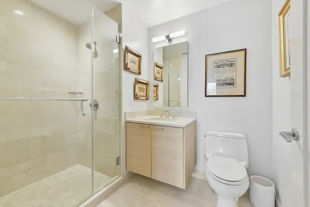 a bathroom with a granite countertop toilet sink and shower