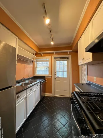 a kitchen with granite countertop a stove and a sink