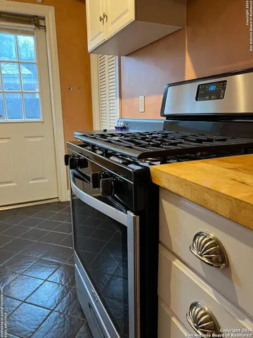 a stove top oven sitting inside of a kitchen