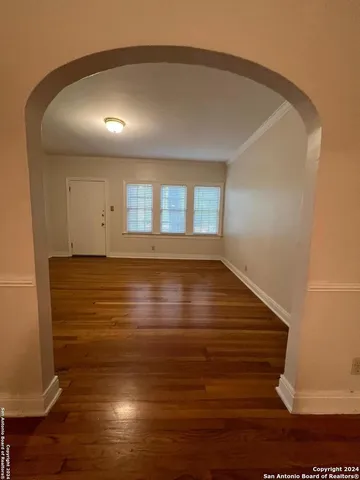 a view of room with wooden floor