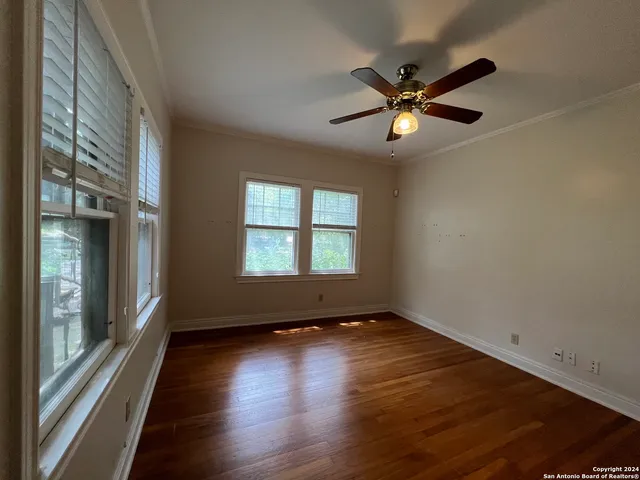wooden floor in an empty room with a window