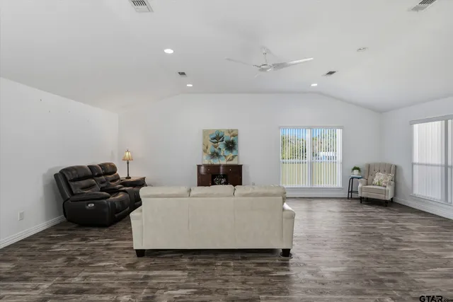 a living room with furniture and wooden floor
