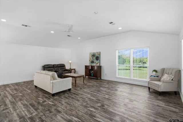 a living room with furniture window and wooden floor
