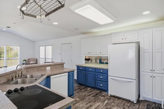a kitchen with a sink appliances a sink and cabinets