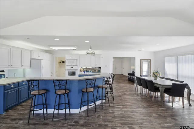 a large kitchen with a table and chairs
