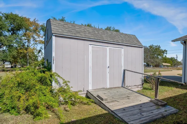 a roof deck with wooden floor and yard