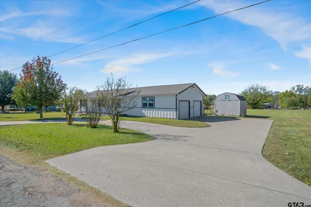 a house with green field in front of it