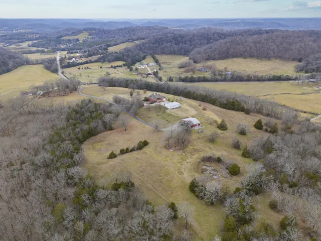 a view of empty room with wooden floor and fireplace