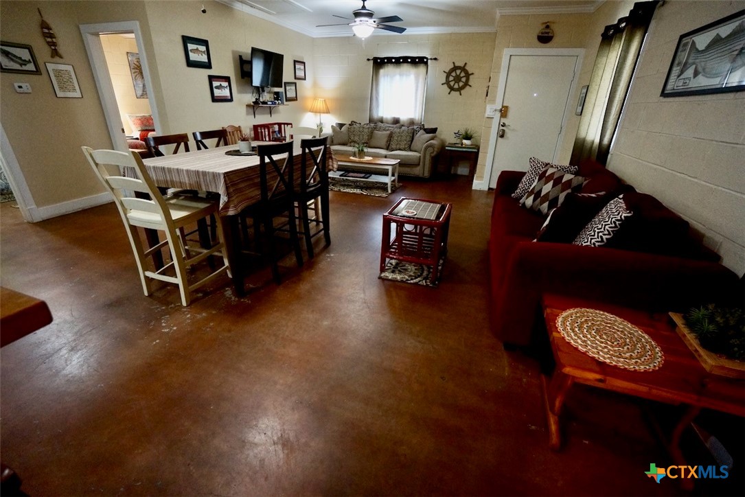 75-unit # 2 75-unit Street Port O'Connor, TX 77982 - Photo 3 of 18 a living room with furniture and a dining table with wooden floor