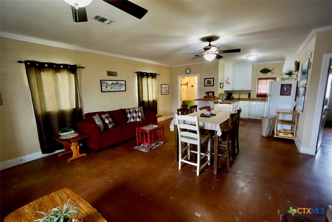 75-unit # 2 75-unit Street Port O'Connor, TX 77982 - Photo 4 of 18 a living room with furniture and a chandelier