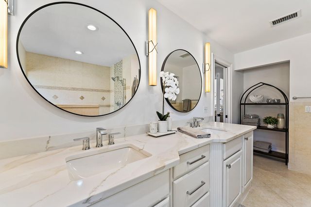 a bed sitting in a spacious bedroom next to a window