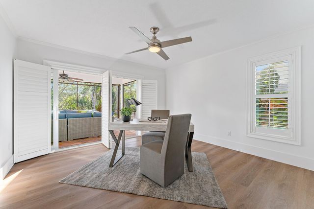 a view of a dining room with furniture a fireplace and wooden floor