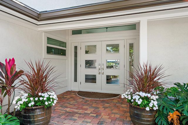 a living room with furniture a potted plant and a fireplace