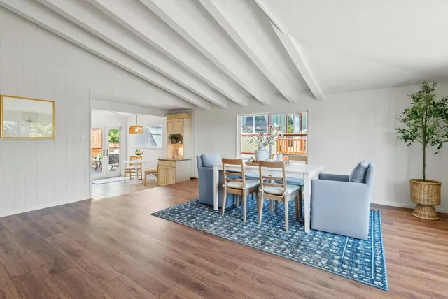 a living room with furniture wooden floor and a potted plant