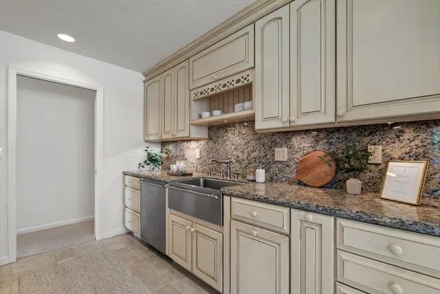 a kitchen with stainless steel appliances granite countertop a sink a stove and a microwave oven