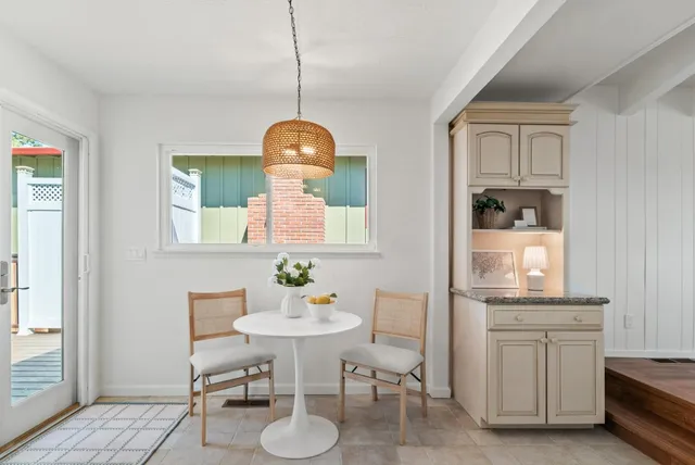 a view of dining room and kitchen with a table chairs