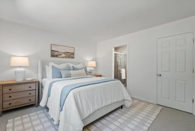 a bedroom with a bed and a night stand