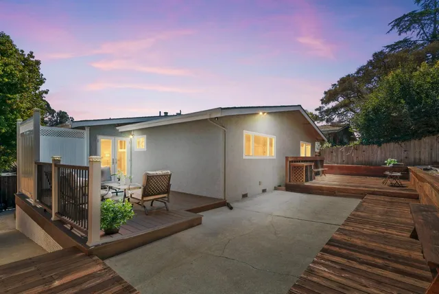 a view of a house with backyard and sitting area