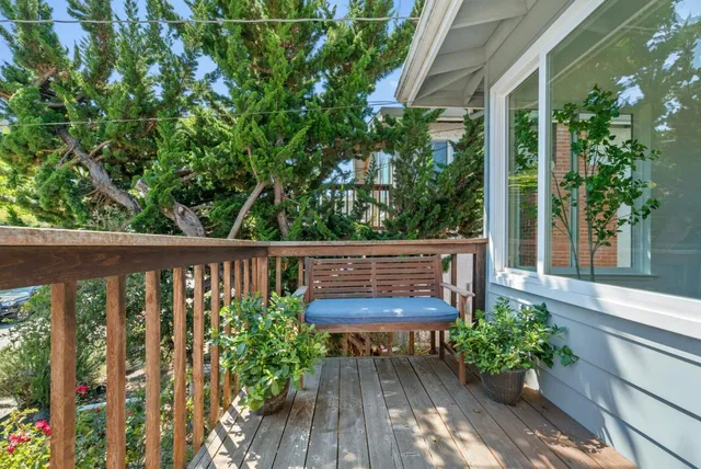 a wooden bench sitting in front of a house