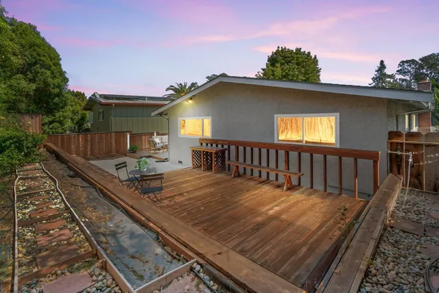 a view of a house with a wooden deck