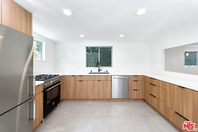 a view of hallway with a large window and wooden floor