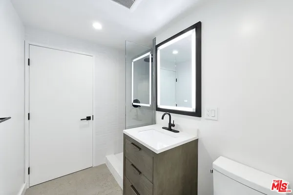 a bathroom with a double vanity sink and mirror