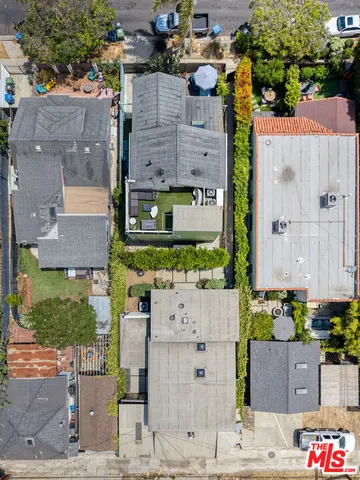 an aerial view of a house with large trees