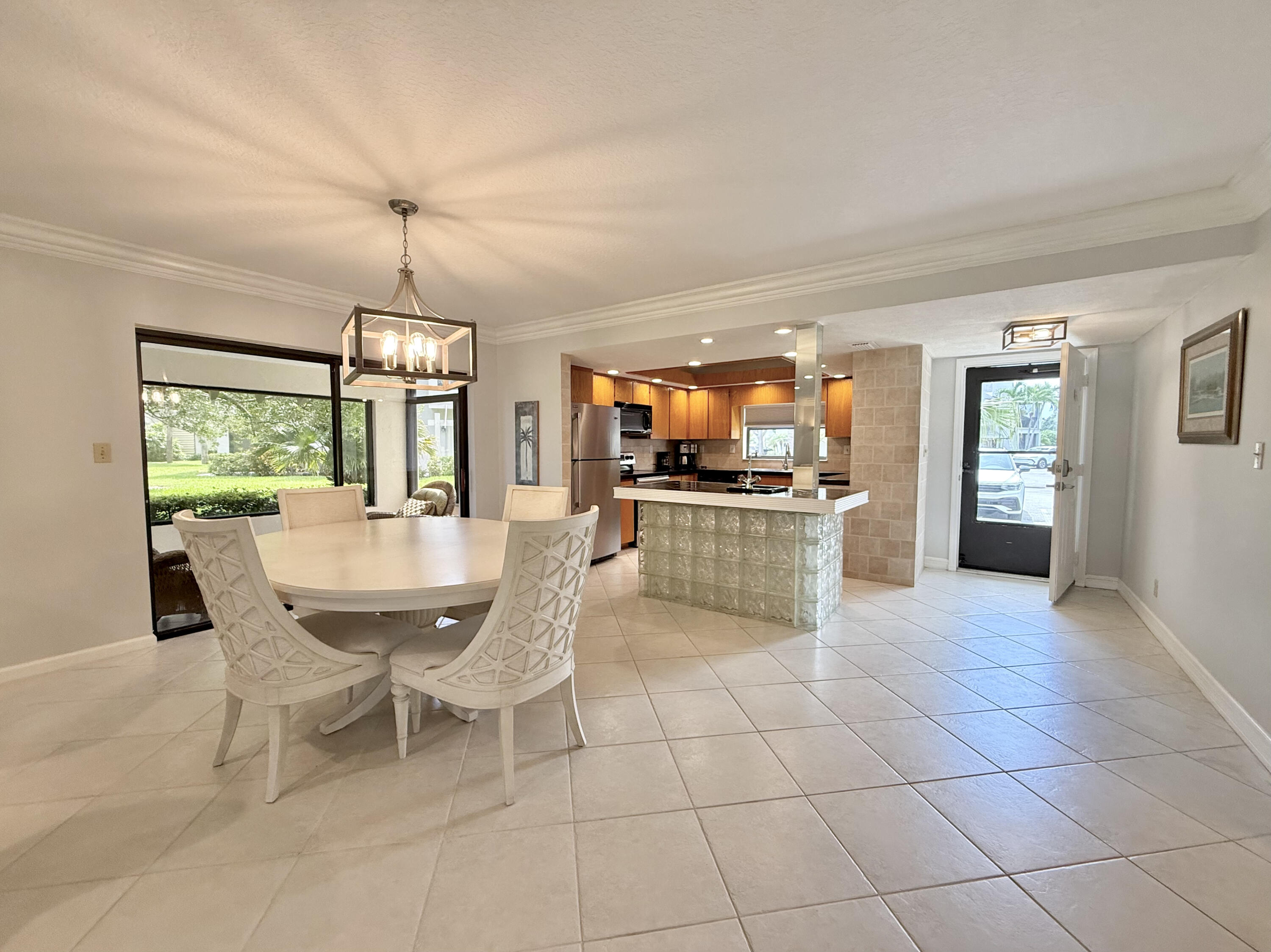 401 Clubhouse Circle, Unit 401A Jupiter, FL 33477 - Photo 2 of 34 a view of a kitchen and dining room