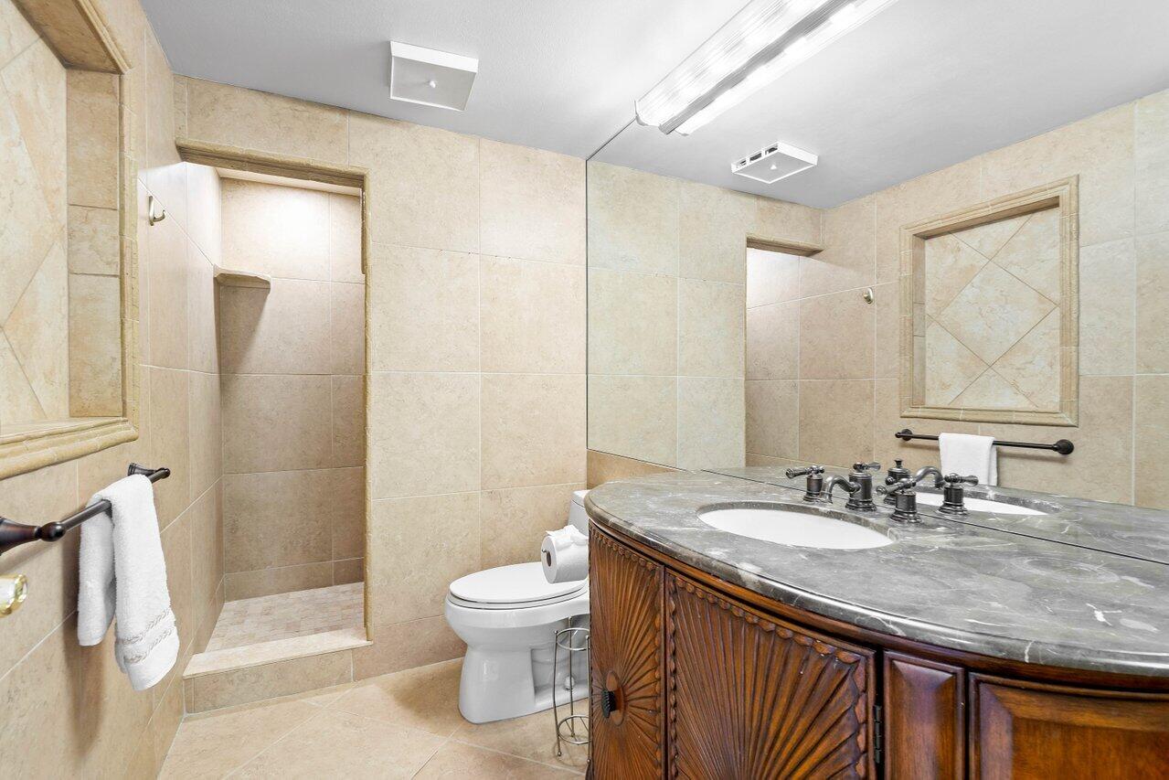 401 Clubhouse Circle, Unit 401A Jupiter, FL 33477 - Photo 22 of 34 a bathroom with a sink a toilet and shower