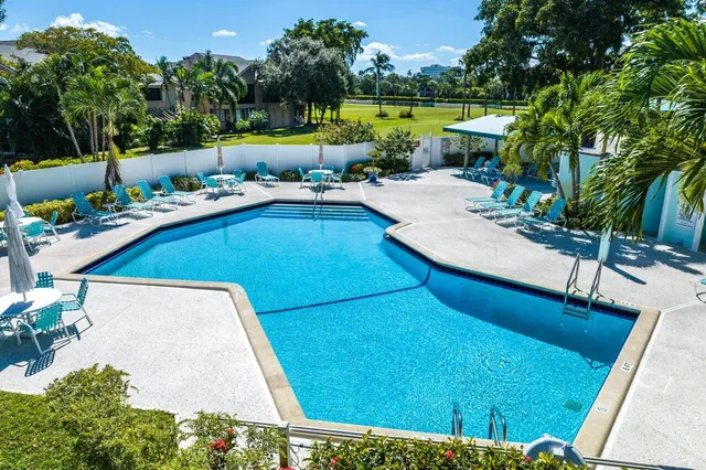 a view of a swimming pool with a patio and a garden